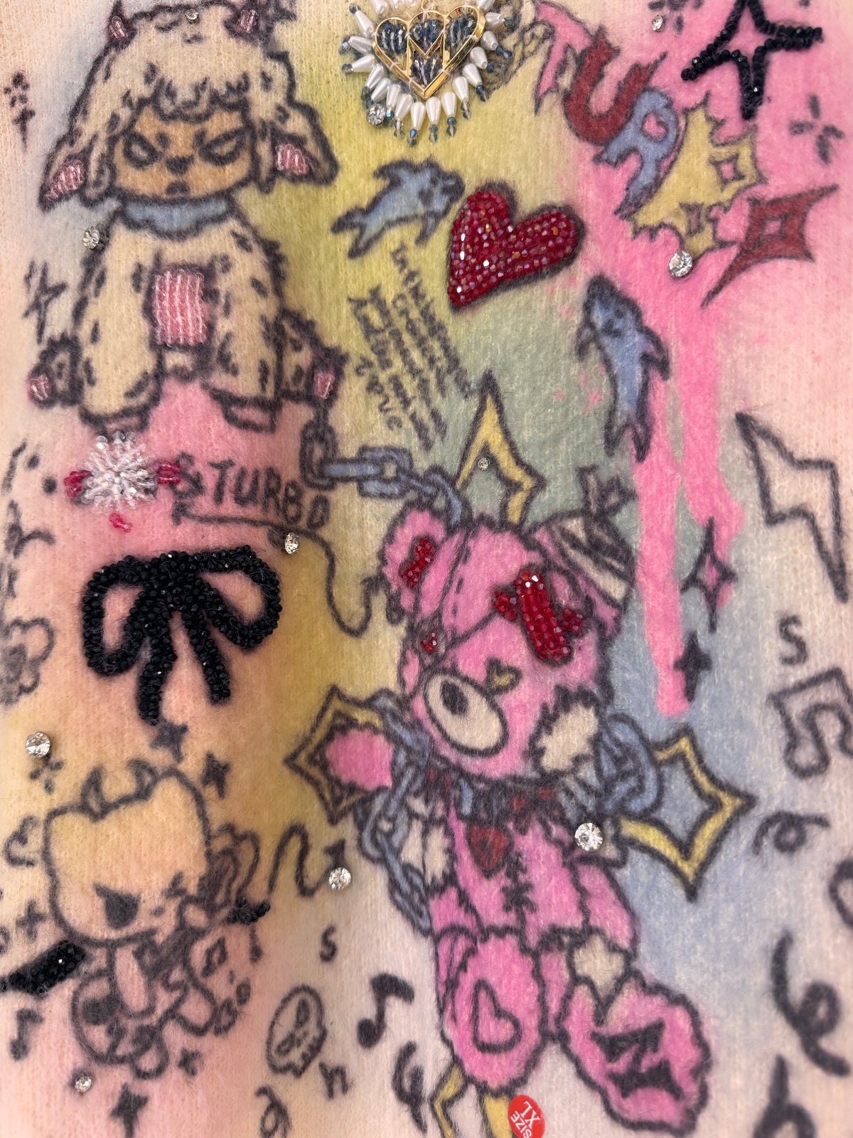 CREAM SWEATER WITH PASTEL CARTOON PRINT