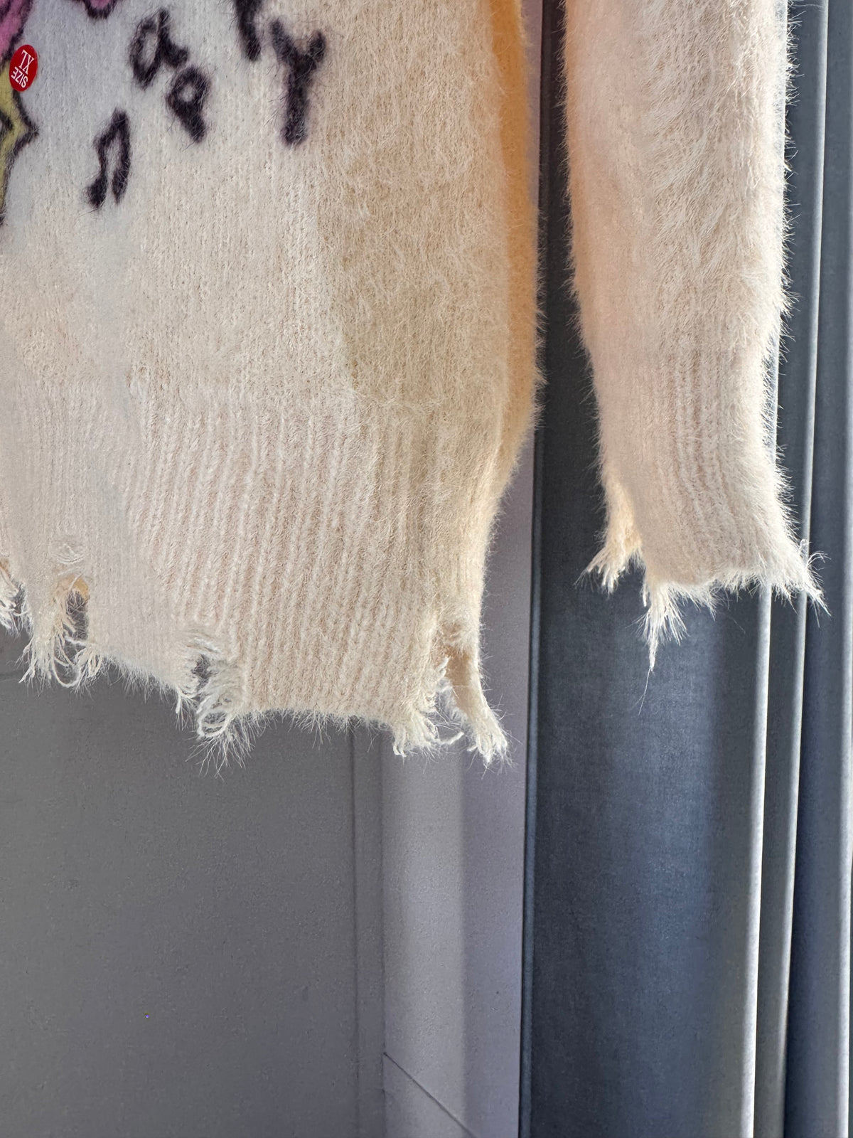 CREAM SWEATER WITH PASTEL CARTOON PRINT